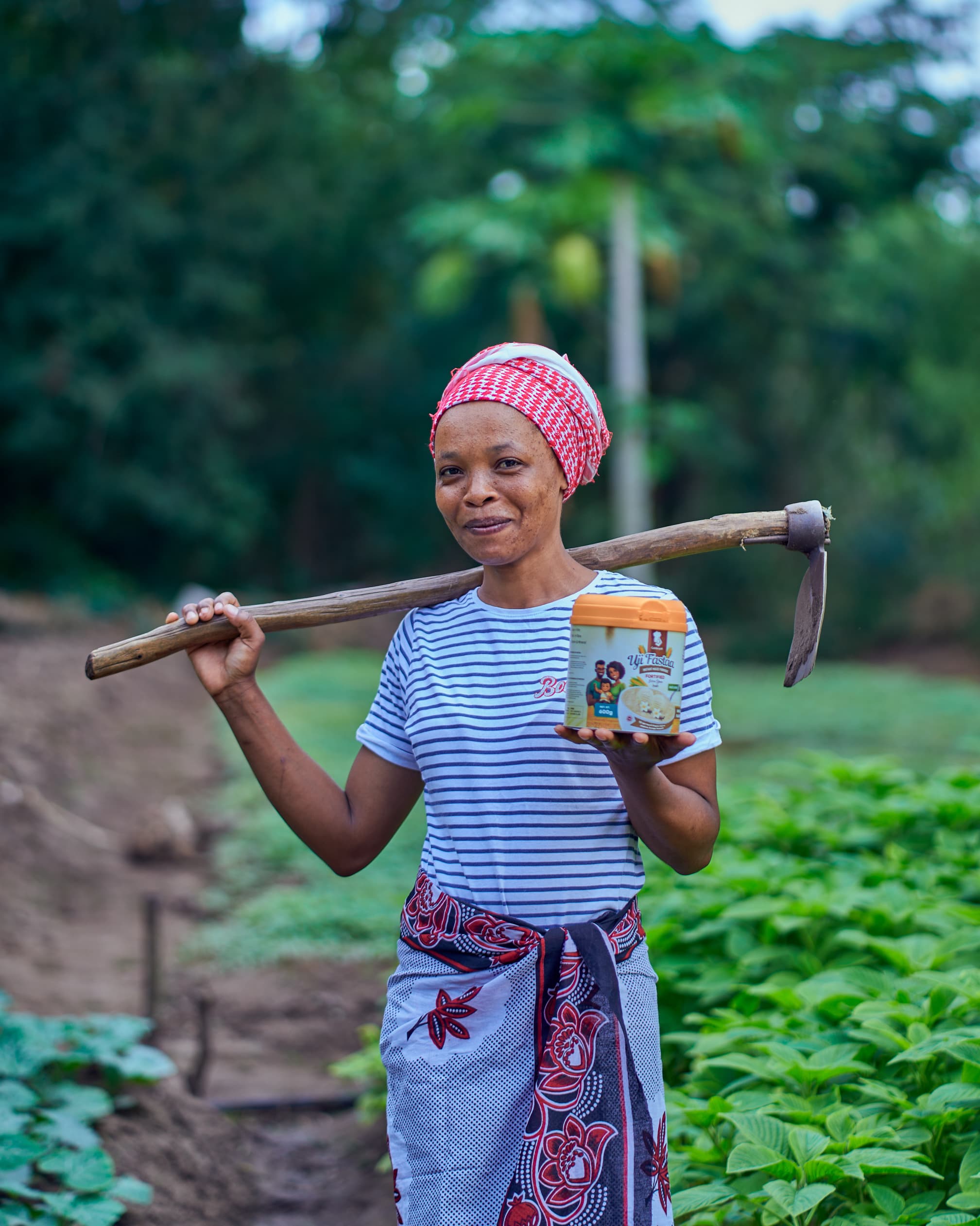 Woman farmer holding Goldenpot product in the field
