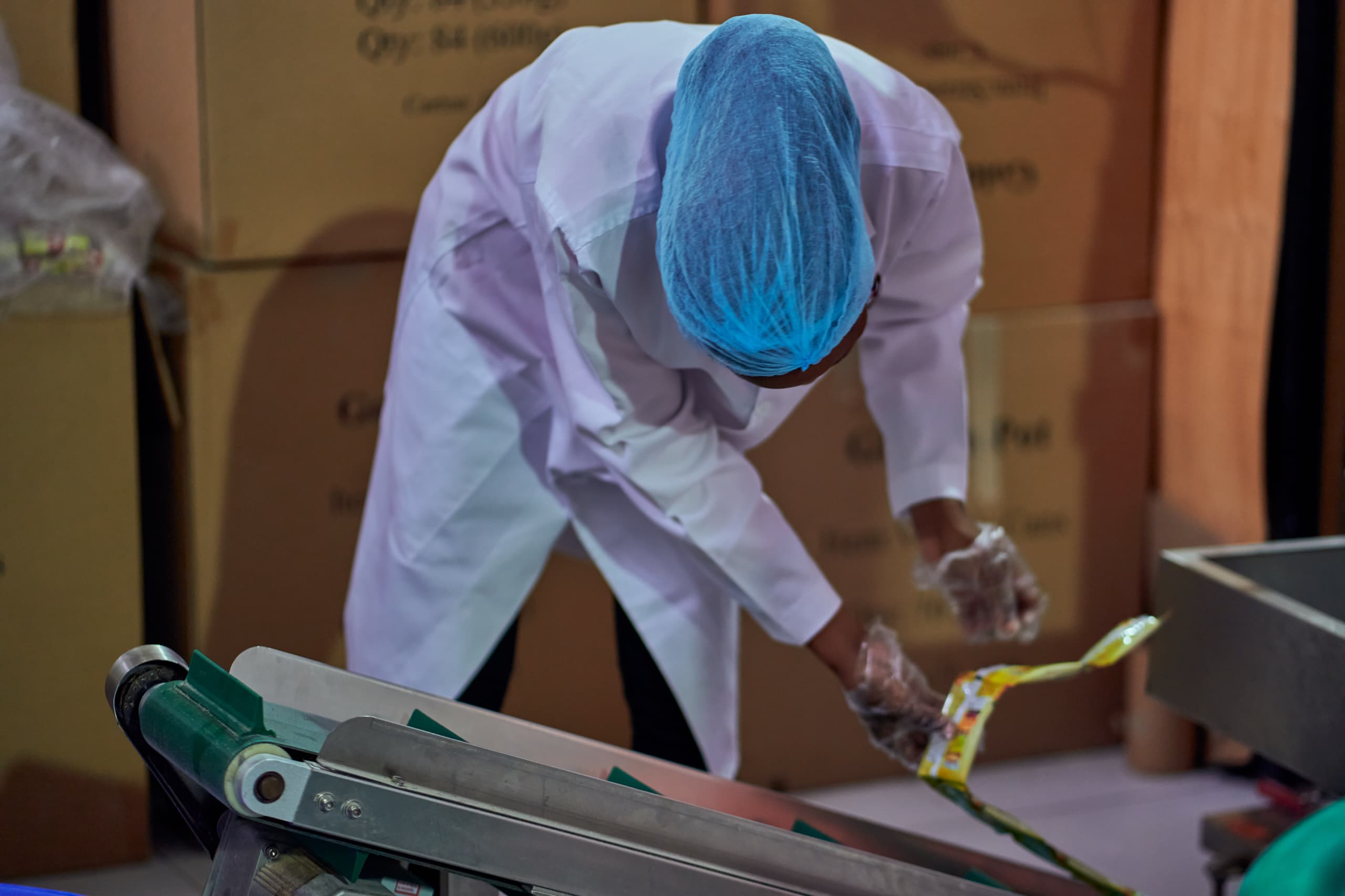 Worker on packaging line at Goldenpot production facility